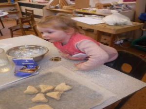 child making heart shapes in dough