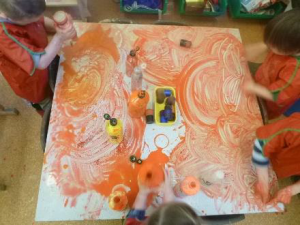 children finger painting