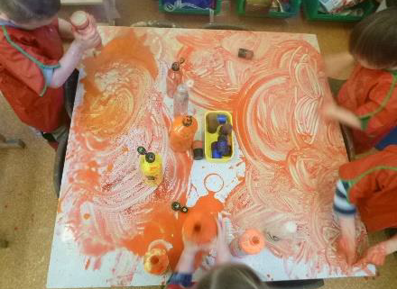 children finger painting