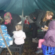 children in forest school shelter