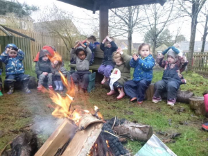 children sitting around campfire