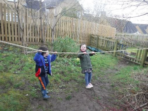 children walking holding rope