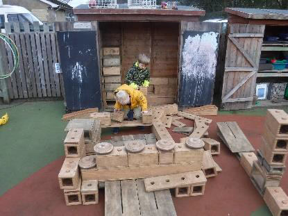 boys with giant blocks outdoors